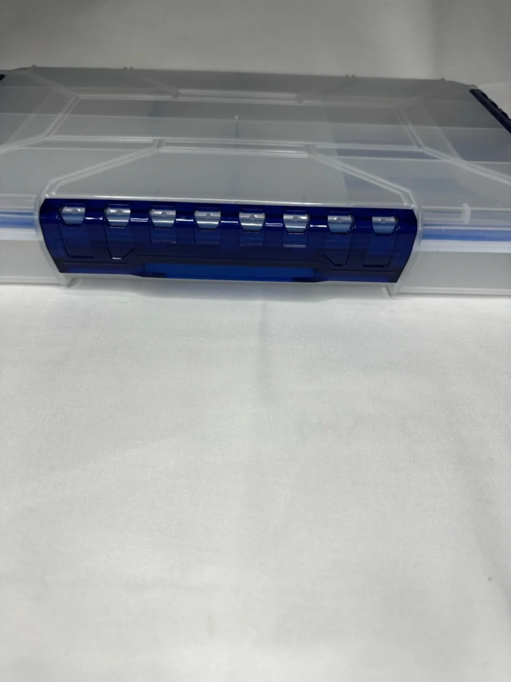 Multi-Compartment Clear Plastic Storage Box with Blue Accents.